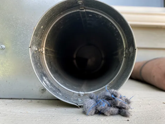 Longmeadow Dryer Vent Cleaning technician using specialized equipment to clear severe dryer vent blockage in Longmeadow